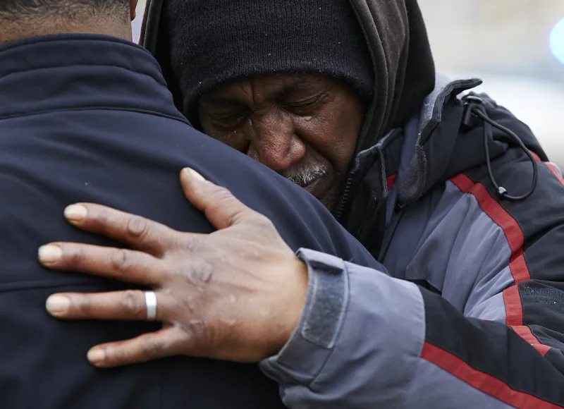 Eli Boyd Sr., a local resident, cries on a family member at Chittock Ave. in Jackson after the shooting on Sunday, April 1st, 2018. "This is everywhere now. It needs to be addressed" he says.