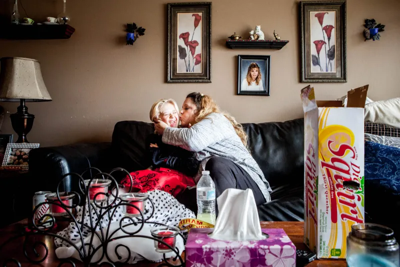 Destiny Turek-Sturgeon, and her mother, Shelly Turek, relax i n their Racine home. Turek is waiting for government approval of her disabilities checks, and hopes to finally pay off her mortgage when the checks start to arrive.