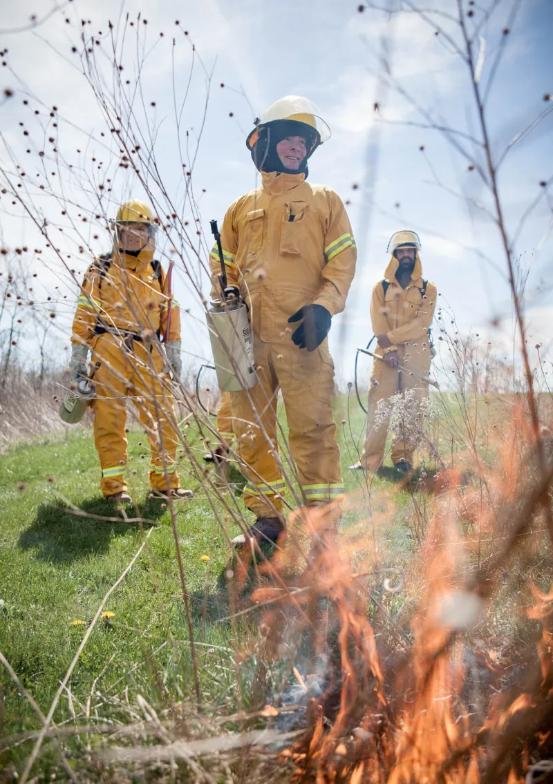 Three volunteer firemen watch a fire they started at the Green Cemetery in Gambier, Ohio.