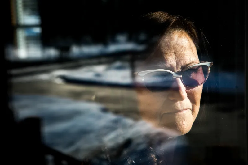 Diane Vanover looks out her front window at an unmaintained stretch of Ridge Road in Superior Township. Hundreds of potholes on the road in front of her home make it almost impassable. "It all started when during the construction near Cherry Hill. ... It's been like this for years, " she says.