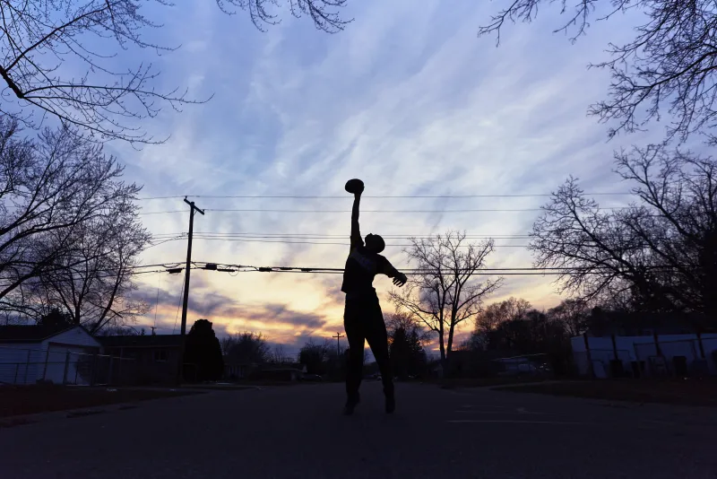 Long time West Willow resident Asante Davis reaches to catch a football, thrown by his friend, Dominic Gaskin on the corner Nash Ave. and Mary Catherine Ave. on in West Willow. “I know this neighborhood like the back of my hand” says Davis.