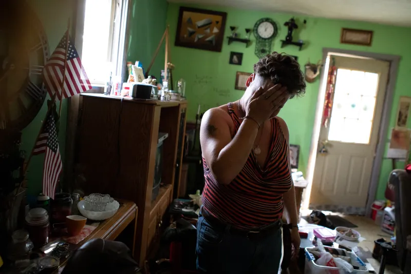 Chauncey, Ohio resident Christina Way wipes sweat away from her face on a hot day in home on Wednesday, September 5, 2018. Christina lives with her husband, Dana Way, Dana's 82 year-old mother and 83 year-old father on two adjacent properties.